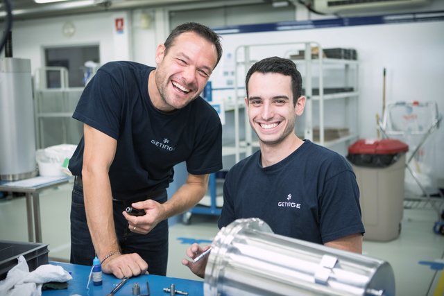 Men in the warehouse smiling