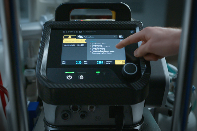 Cardiohelp II Extracorporeal Life Support screen close up with hand