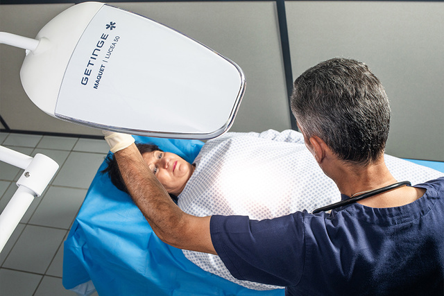 doctor illuminating a patient with an examination lamp