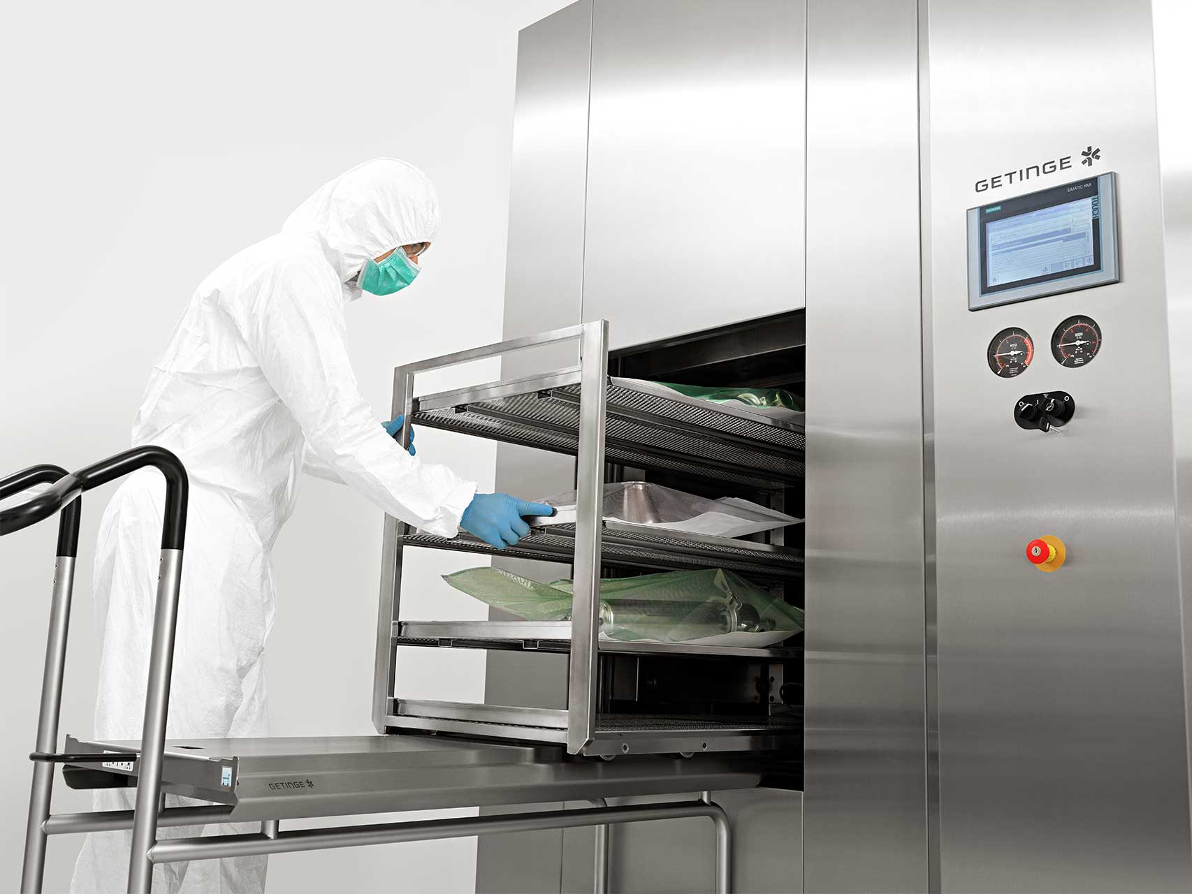 A man is loading the GSS Steam Sterilizer with equipment for biopharmaceutical production