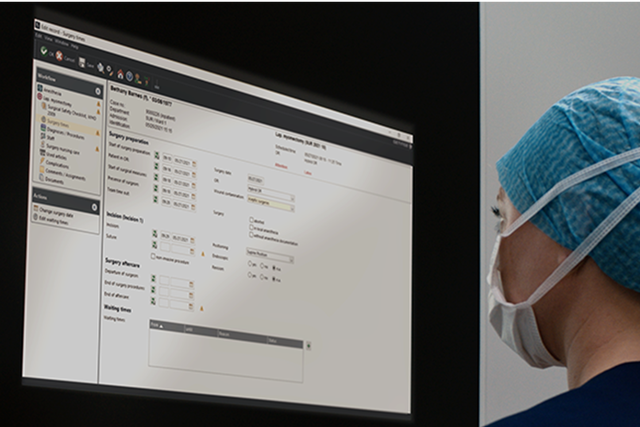 Nurse in the operating room dcouments in Torin OR Management the surgery times