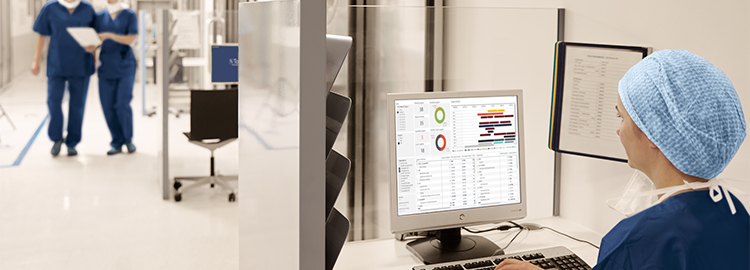 OR  staff checks business intelligence data for optimized decion support with Torin OR management solution from Getinge 