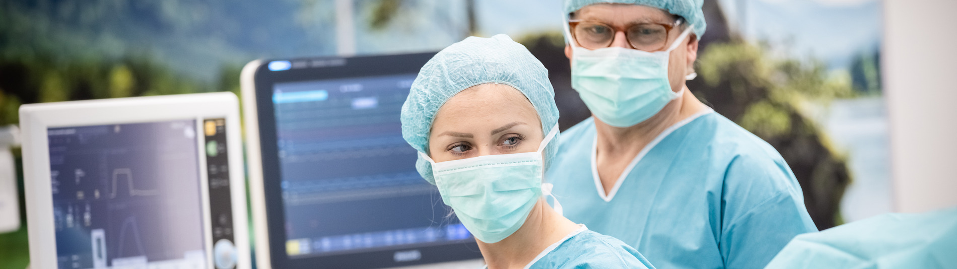 Nurses monitoring patient in hybrid OR