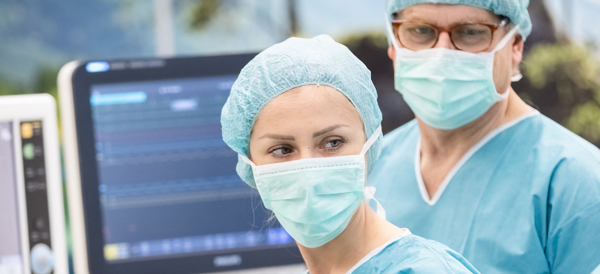 Nurses monitoring patient in hybrid OR