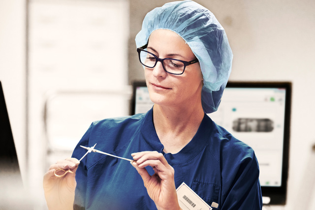 Nurse inspecting sterilized instruments